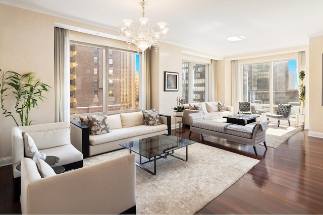 living area with baseboards, a chandelier, ornamental molding, and wood finished floors