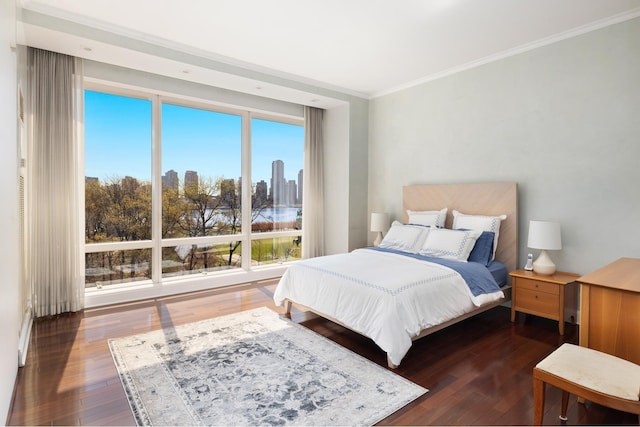 bedroom with wood-type flooring and ornamental molding