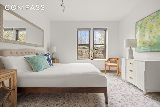 bedroom featuring baseboard heating and baseboards