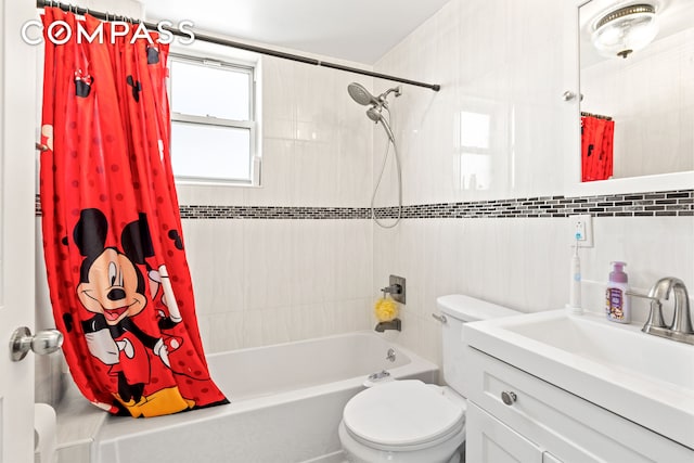 full bath featuring tile walls, vanity, shower / bathtub combination with curtain, and toilet