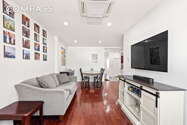 living room with recessed lighting and dark wood-style floors