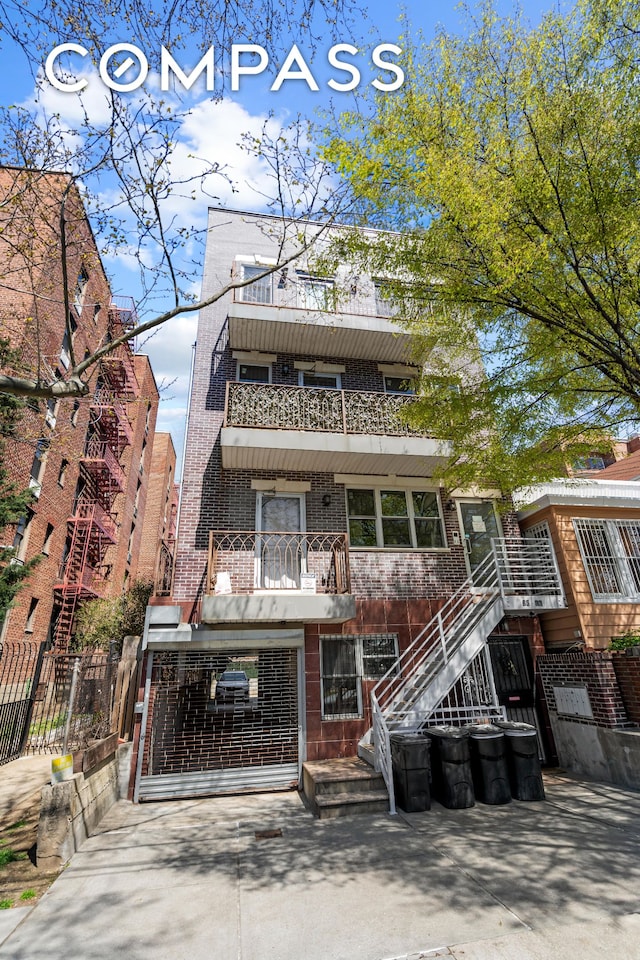 view of property with fence and stairs