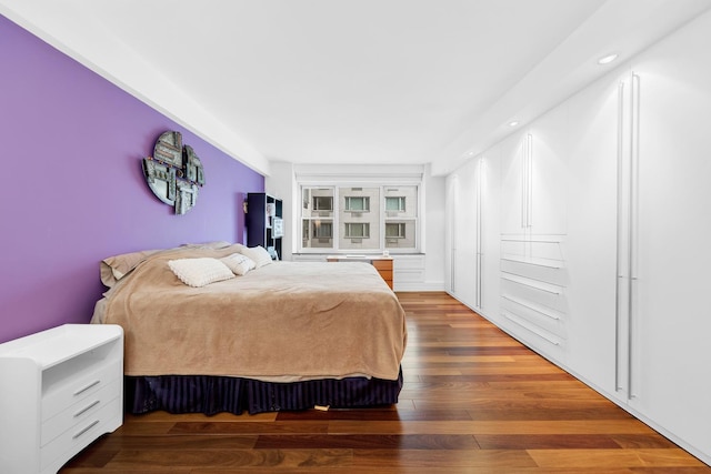 bedroom with wood finished floors and recessed lighting