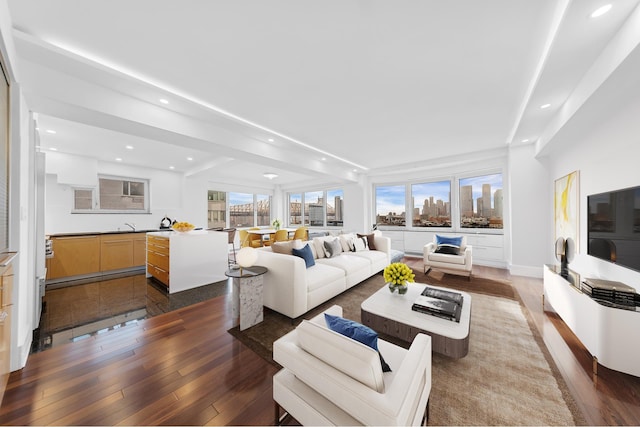living room featuring recessed lighting, healthy amount of natural light, and dark wood-type flooring