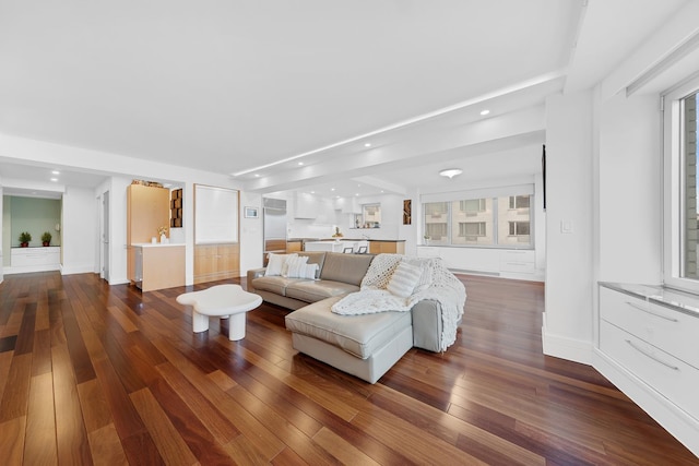living area with recessed lighting, dark wood-type flooring, and beam ceiling