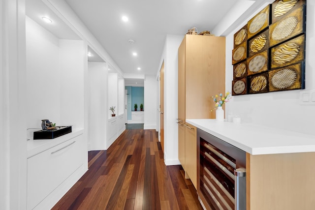 hallway with beverage cooler, recessed lighting, and dark wood-style floors
