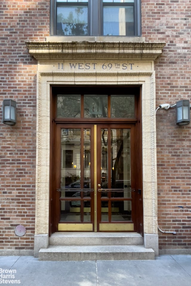 doorway to property featuring brick siding