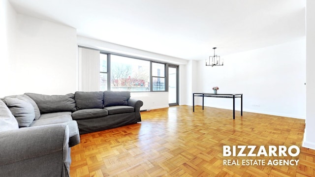 living room featuring baseboards and a chandelier