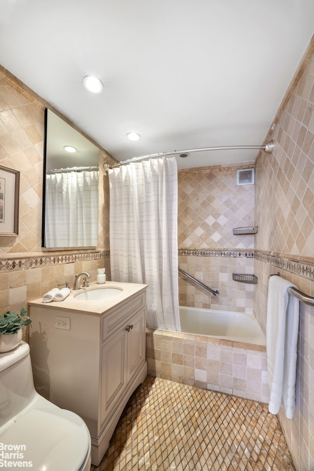 175 E 62nd St Unit 8B, New York City, NY 10065 - full bath with tile walls, toilet, tiled shower / bath combo, vanity, and tile patterned flooring