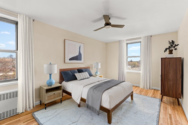 221 Mcdonald Ave Unit 6B, New York City, NY 11218 - bedroom featuring radiator, light wood-type flooring, baseboards, and a ceiling fan