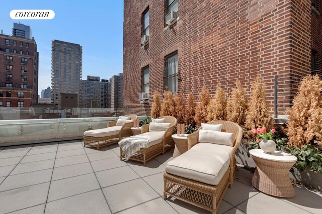view of patio / terrace featuring a view of city and an outdoor hangout area