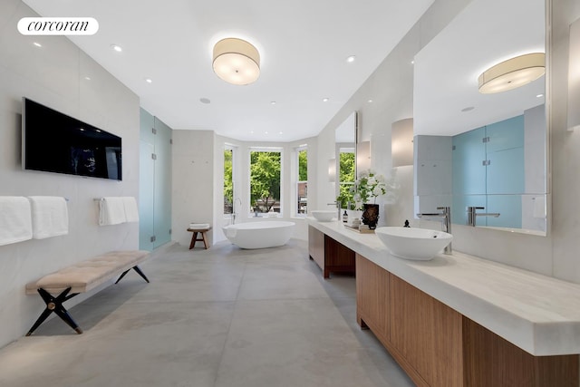 226 W 71st St, New York City, NY 10023 - bathroom featuring vanity, concrete flooring, a freestanding tub, a stall shower, and recessed lighting