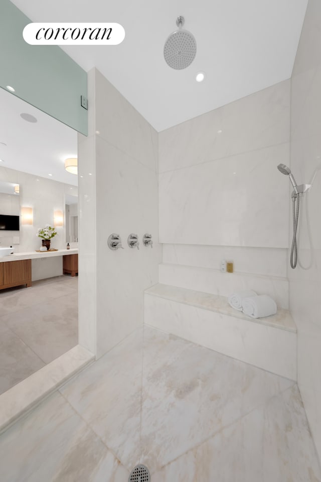 bathroom featuring vanity, walk in shower, and recessed lighting