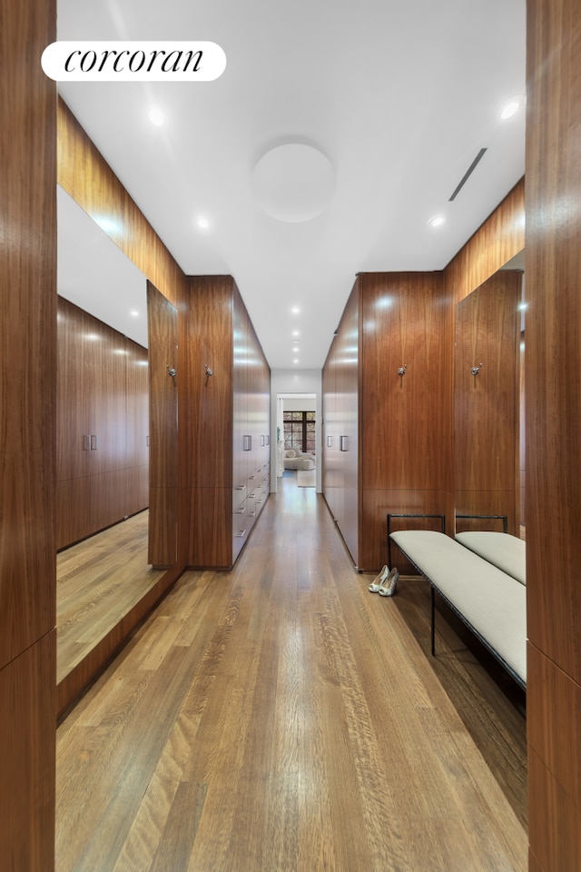 corridor with visible vents and light wood-style flooring
