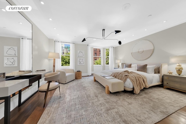 bedroom with baseboards, recessed lighting, wood finished floors, and visible vents