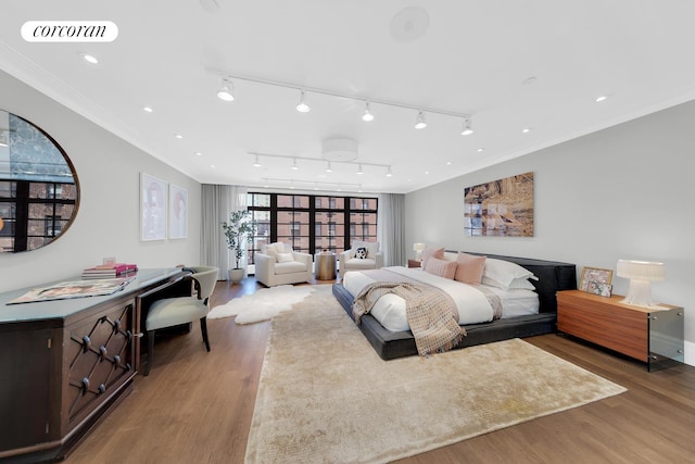 bedroom featuring crown molding, visible vents, and light wood-style floors