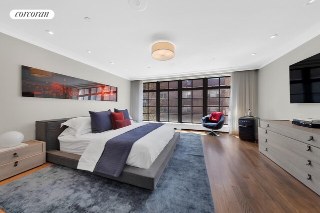 bedroom with crown molding, recessed lighting, wood finished floors, and visible vents