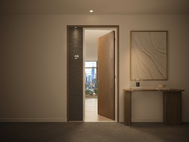 corridor with carpet flooring, recessed lighting, and baseboards