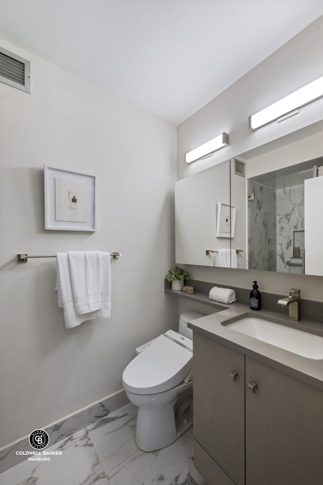 full bath with marble look tiles, a walk in shower, toilet, vanity, and baseboards