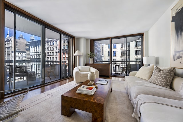 108 5th Ave Unit 8B, New York City, NY 10011 - living room with floor to ceiling windows, a view of city, wood finished floors, and healthy amount of natural light