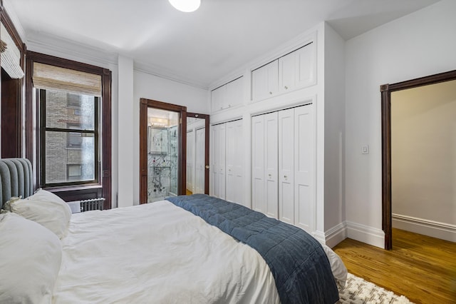 120 E 85th St Unit 2-E, New York City, NY 10028 - bedroom with baseboards, multiple closets, and wood finished floors
