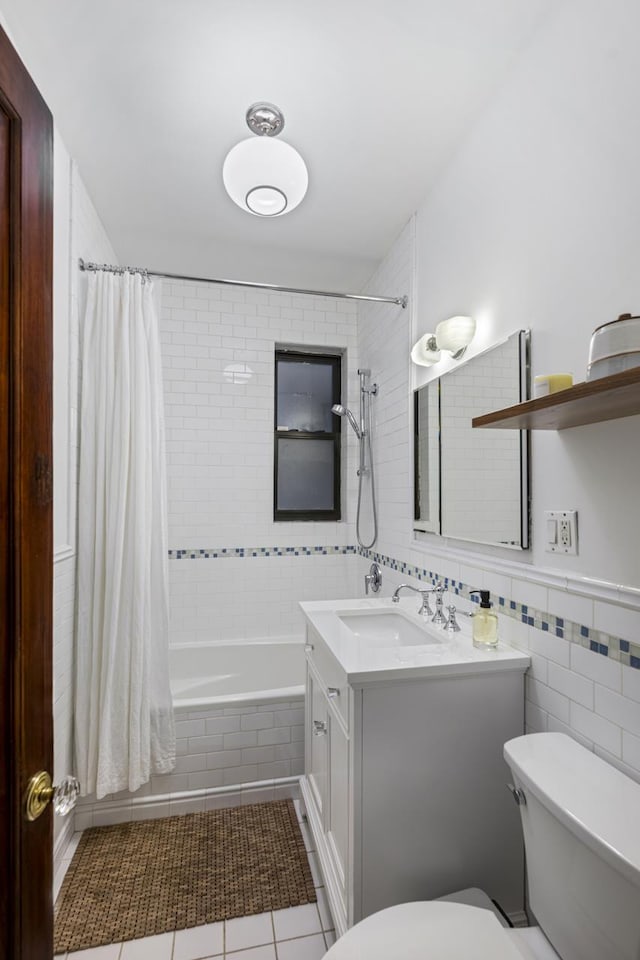 120 E 85th St Unit 2-E, New York City, NY 10028 - bathroom with toilet, tiled shower / bath combo, vanity, tile walls, and tile patterned floors