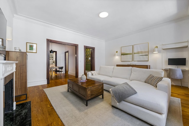 120 E 85th St Unit 2-E, New York City, NY 10028 - living area featuring ornamental molding, wood finished floors, a premium fireplace, and baseboards