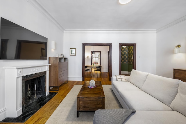 120 E 85th St Unit 2-E, New York City, NY 10028 - living area with ornamental molding, wood finished floors, and a fireplace