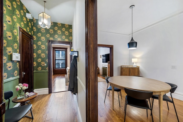 120 E 85th St Unit 2-E, New York City, NY 10028 - dining room with wood finished floors, wallpapered walls, and baseboards