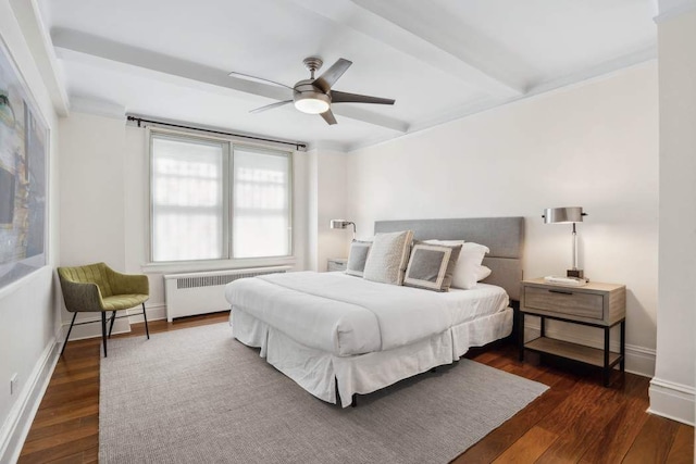 bedroom featuring radiator, dark wood-type flooring, baseboards, a ceiling fan, and beam ceiling