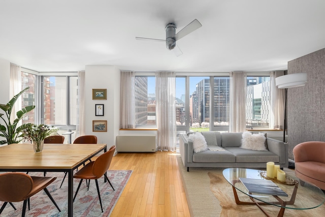 225 W 60th St Unit 14F, New York City, NY 10023 - dining room with ceiling fan, light wood-style flooring, and a view of city