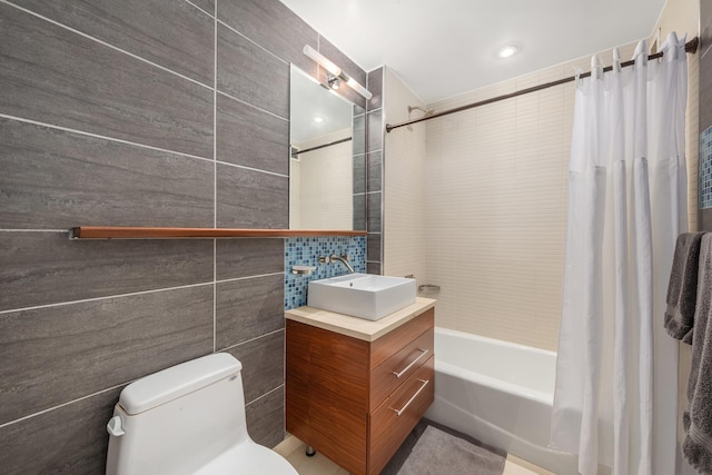 225 W 60th St Unit 14F, New York City, NY 10023 - full bath with tile walls, vanity, shower / bathtub combination with curtain, and toilet