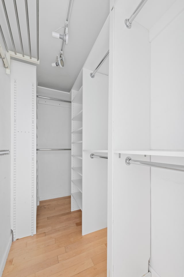 spacious closet with wood finished floors