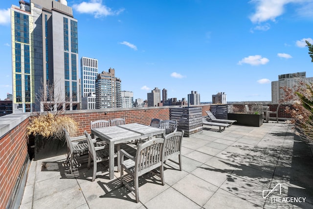 view of patio with a skyline view and outdoor dining space