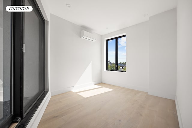 1048 Flushing Ave Unit 4L, New York City, NY 11237 - unfurnished room with a wall unit AC, light wood finished floors, and baseboards