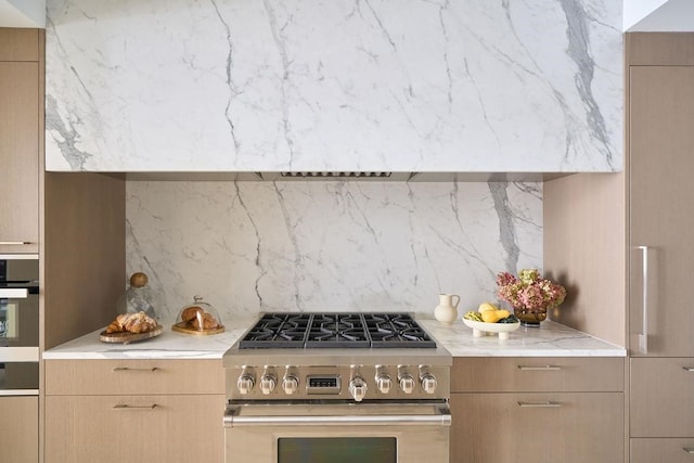200 Amsterdam Ave Unit 7B, New York City, NY 10023 - kitchen featuring stainless steel appliances, backsplash, modern cabinets, and light stone countertops
