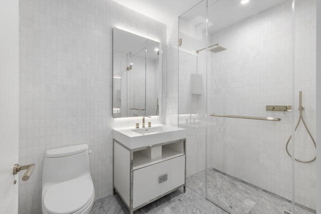200 Amsterdam Ave Unit 7B, New York City, NY 10023 - full bathroom featuring vanity, a stall shower, toilet, tile walls, and marble finish flooring
