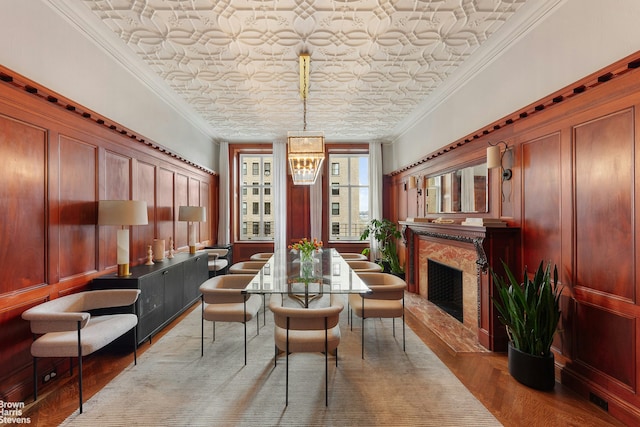 390 W End Ave Unit 5H, New York City, NY 10024 - dining room featuring a chandelier, wood finished floors, a premium fireplace, an ornate ceiling, and ornamental molding