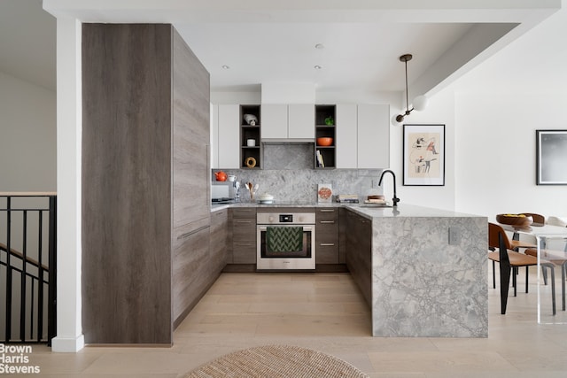 444 Pulaski St Unit 1, New York City, NY 11221 - kitchen featuring oven, modern cabinets, open shelves, and a peninsula