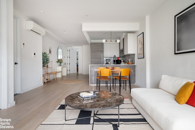 444 Pulaski St Unit 1, New York City, NY 11221 - living area featuring an AC wall unit and light wood-type flooring