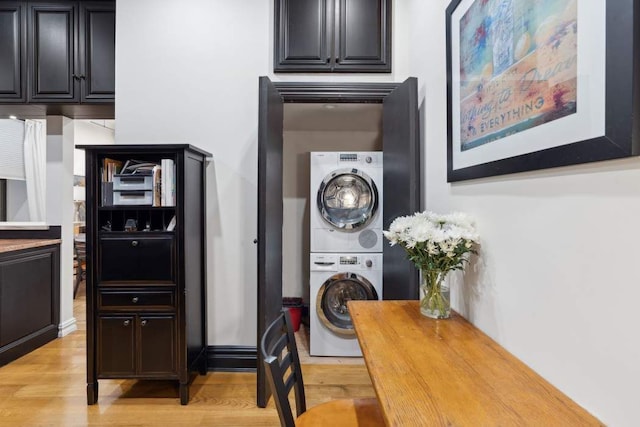 229 W 97th St Unit 1E, New York City, NY 10025 - laundry room with light wood-type flooring, laundry area, and stacked washer and dryer
