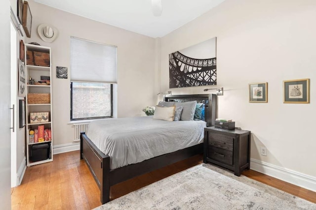 229 W 97th St Unit 1E, New York City, NY 10025 - bedroom with wood finished floors, a ceiling fan, baseboards, and radiator heating unit