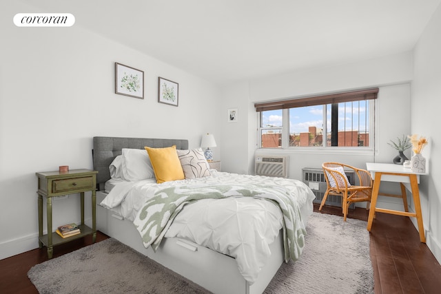609 Columbus Ave Unit 14K, New York City, NY 10024 - bedroom with wood finished floors, baseboards, and an AC wall unit