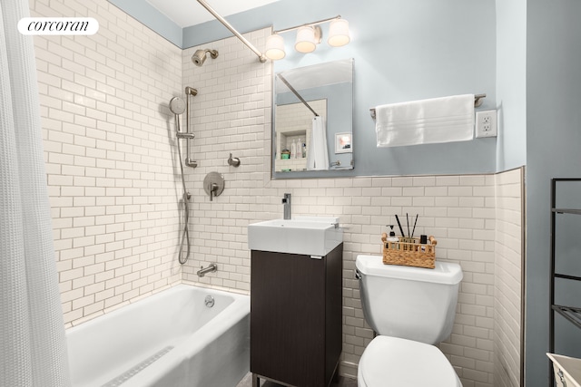 bathroom with shower / bathtub combination with curtain, toilet, tile walls, and vanity