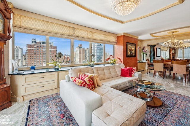 living room featuring a chandelier, a view of city, ornamental molding, light marble finish flooring, and a tray ceiling