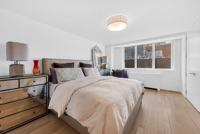 bedroom with baseboards and wood finished floors
