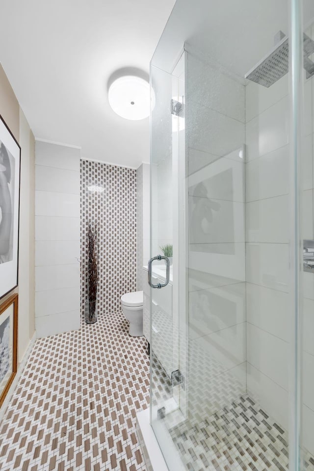 full bath with toilet and a shower stall