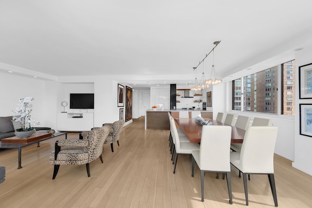 dining room with recessed lighting, a chandelier, and light wood-type flooring
