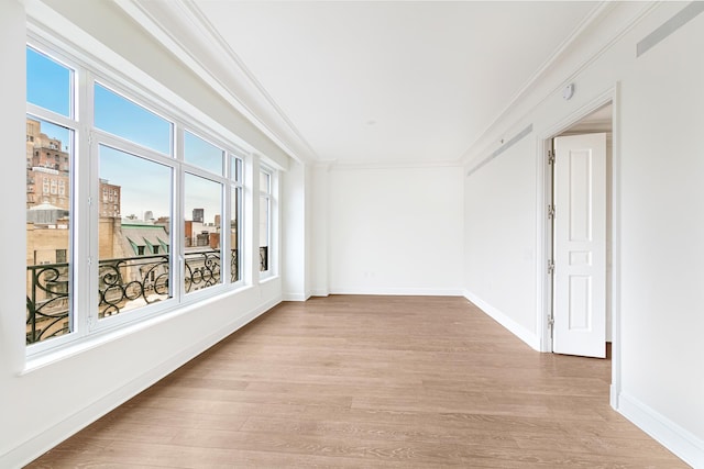 27 E 79th St Unit Duplex7/8, New York City, NY 10075 - spare room featuring crown molding, light wood-style flooring, and baseboards