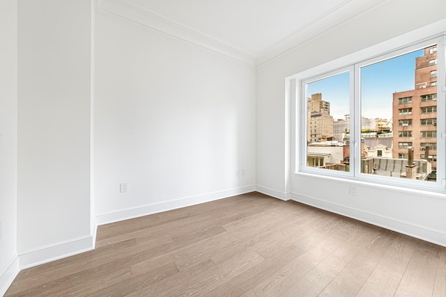 27 E 79th St Unit Duplex7/8, New York City, NY 10075 - unfurnished room with wood finished floors, crown molding, baseboards, and a view of city